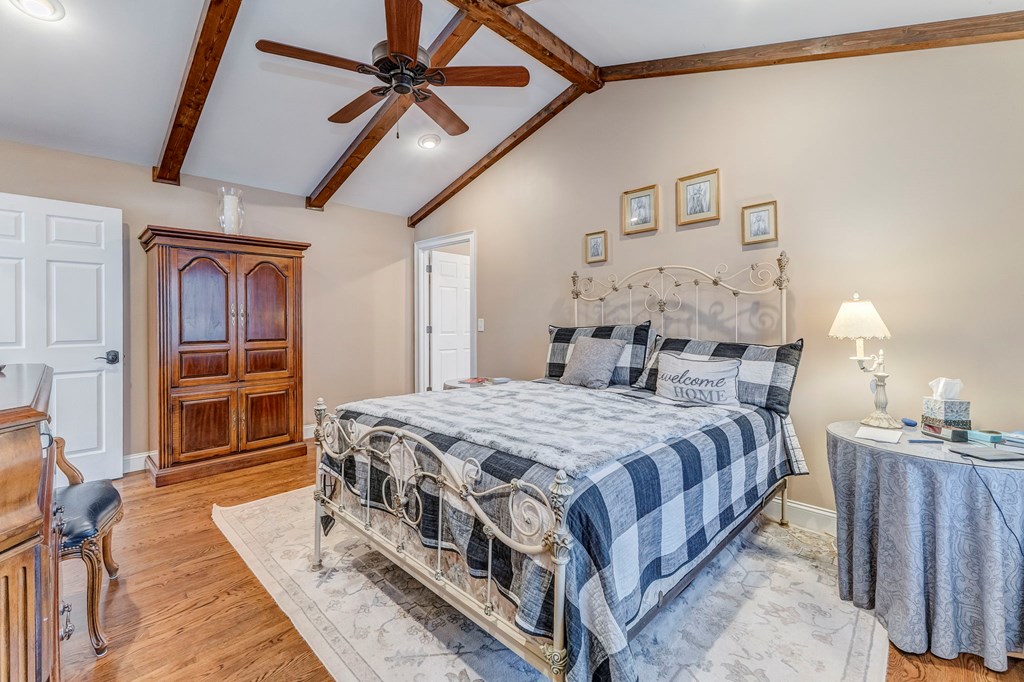 382 Adventure Trail Ellijay, GA 30536 - Photo 23 of 75 a bedroom with a bed next to a window and a chandelier