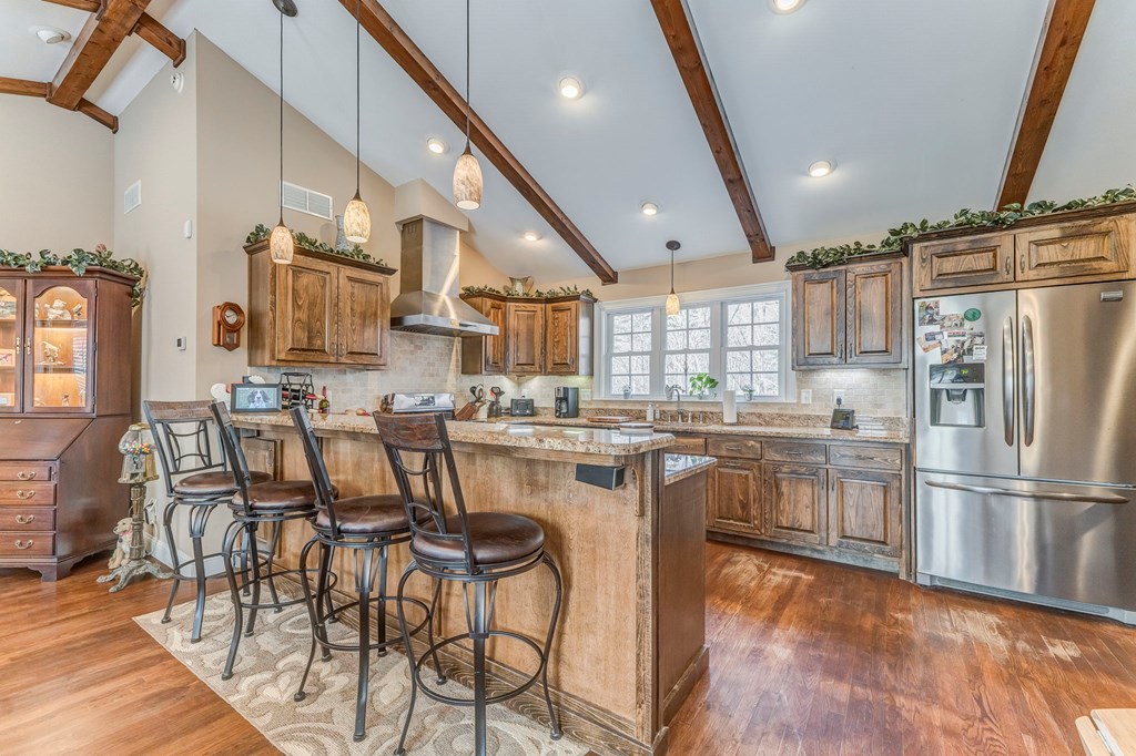382 Adventure Trail Ellijay, GA 30536 - Photo 45 of 75 a kitchen with stainless steel appliances a refrigerator a stove a sink dishwasher with a dining table and chairs