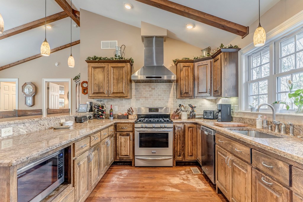 382 Adventure Trail Ellijay, GA 30536 - Photo 46 of 75 a kitchen with stainless steel appliances granite countertop a stove and a sink