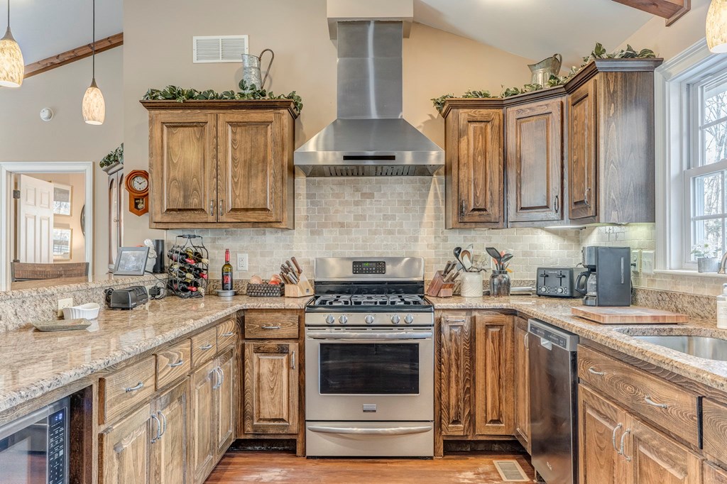 382 Adventure Trail Ellijay, GA 30536 - Photo 47 of 75 a kitchen with granite countertop a stove top oven a sink dishwasher and cabinets