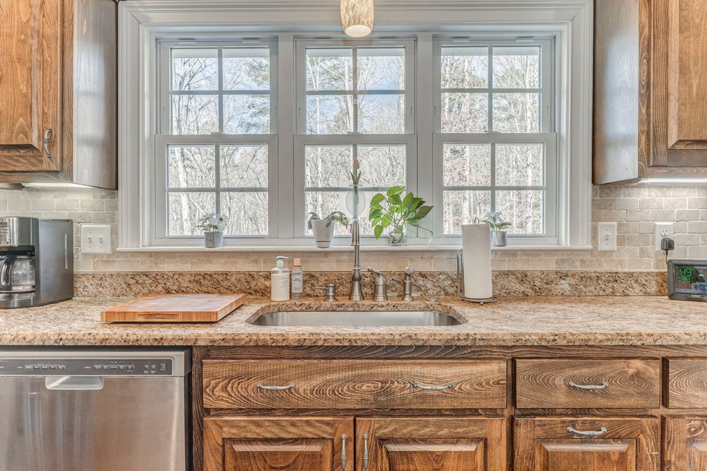 382 Adventure Trail Ellijay, GA 30536 - Photo 49 of 75 a kitchen with granite countertop a sink and a window