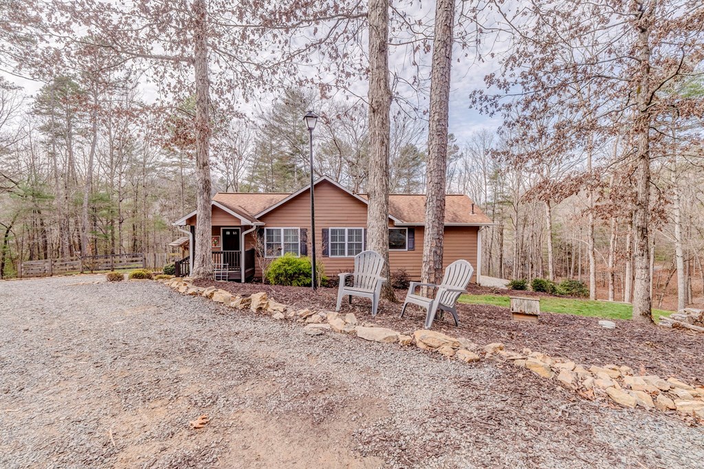 382 Adventure Trail Ellijay, GA 30536 - Photo 73 of 75 a front view of a house with large trees and wooden fence