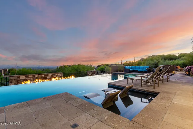 a view of swimming pool with outdoor seating and lake view