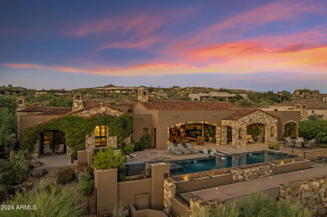 a bathroom with a granite countertop sink a toilet a mirror and shower
