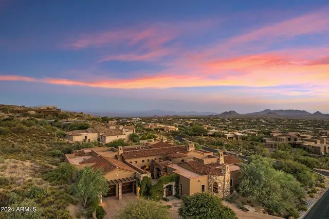 an aerial view of residential houses with outdoor space and trees
