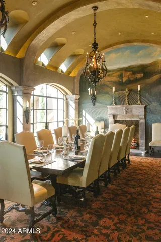 a living room with fireplace furniture and a chandelier