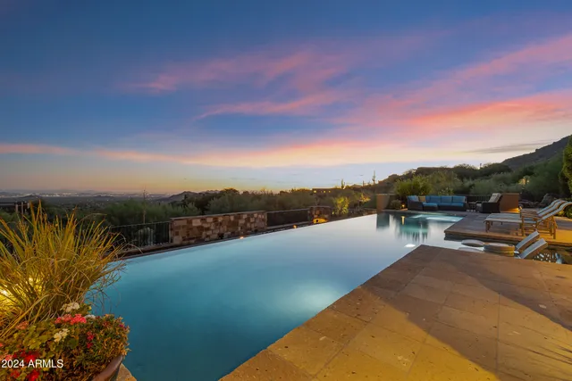 a view of a swimming pool with outdoor seating