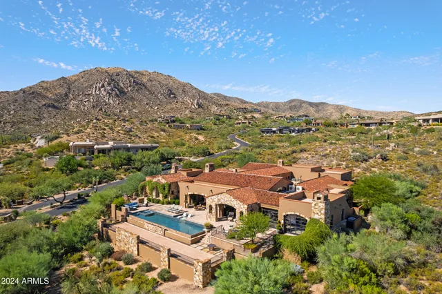 a view of a fountain with a bench in patio