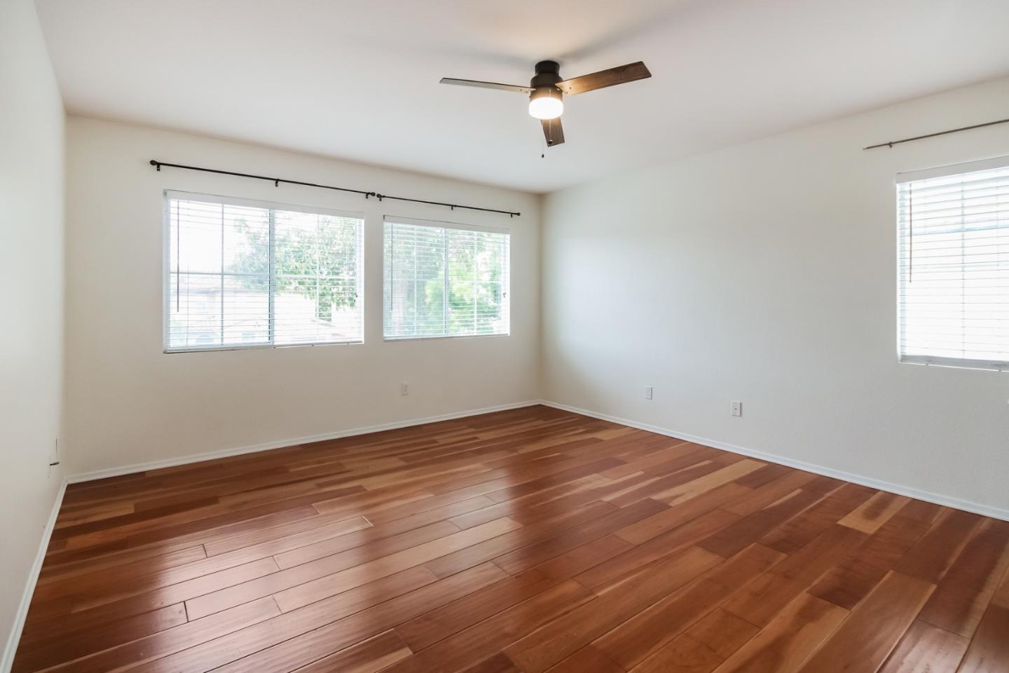 1103 Greenway Road Oceanside, CA 92057 - Photo 15 of 24 a view of an empty room with wooden floor and a window