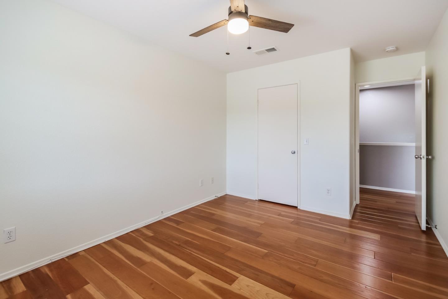 1103 Greenway Road Oceanside, CA 92057 - Photo 18 of 24 an empty room with wooden floor and ceiling fan