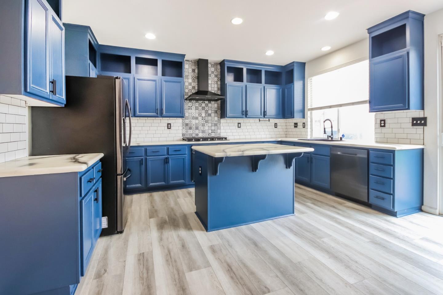 1103 Greenway Road Oceanside, CA 92057 - Photo 9 of 24 a kitchen with stainless steel appliances kitchen island granite countertop wooden cabinets sink and stove