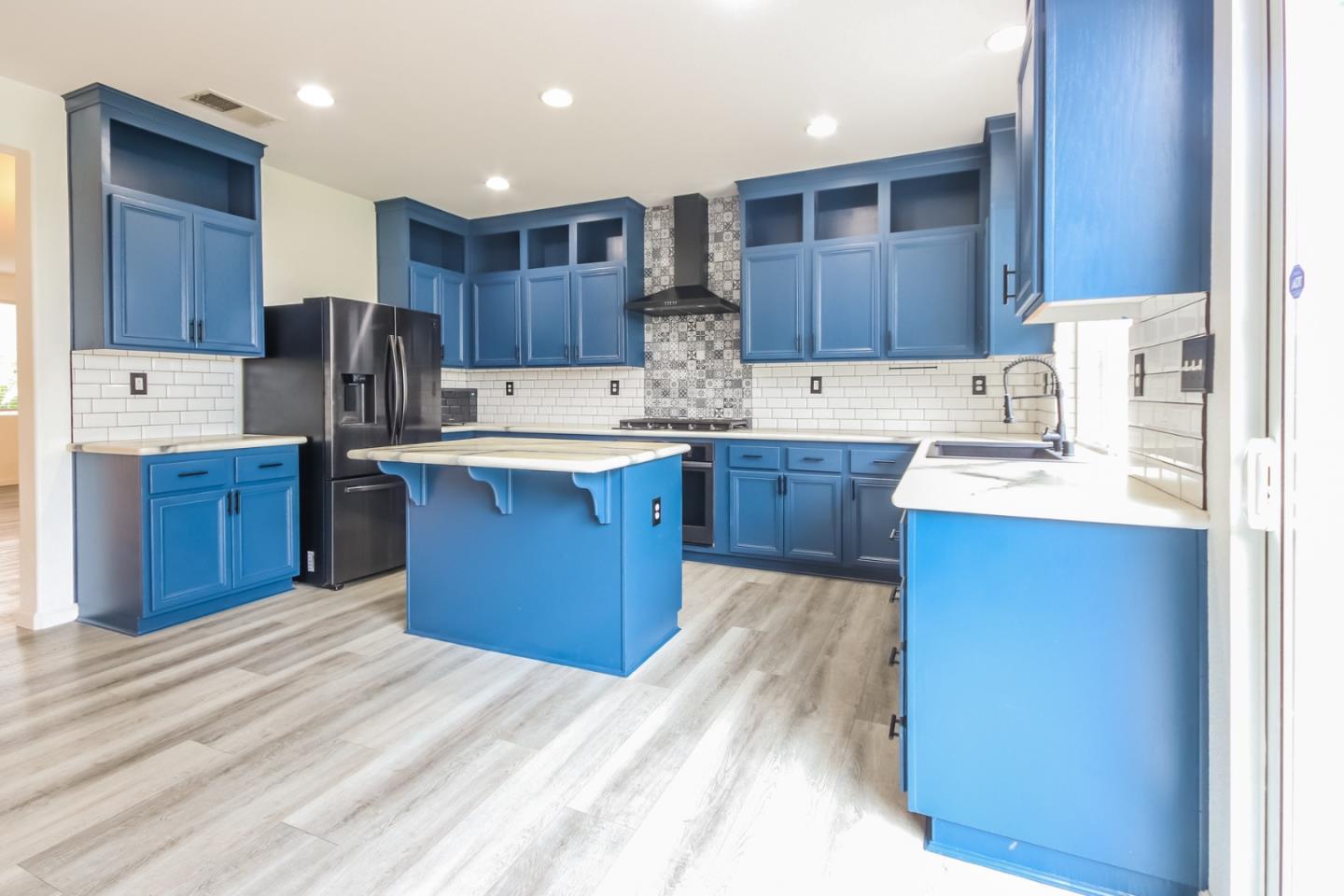 1103 Greenway Road Oceanside, CA 92057 - Photo 10 of 24 a large kitchen with wooden cabinets stainless steel appliances