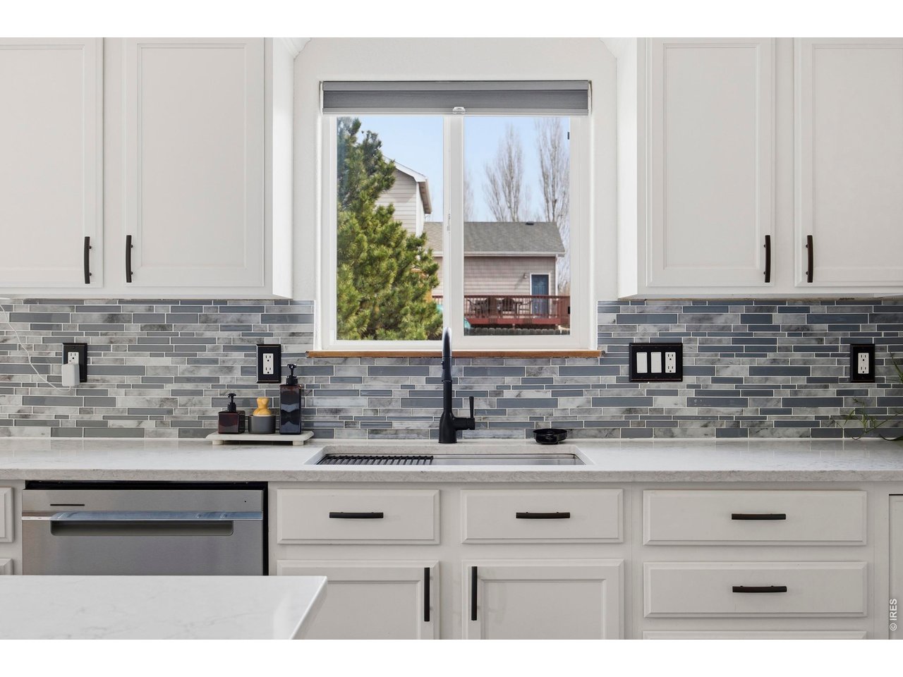 414 Prairie Clover Way Severance, CO 80550 - Photo 11 of 49 a kitchen with stainless steel appliances white cabinets and a sink