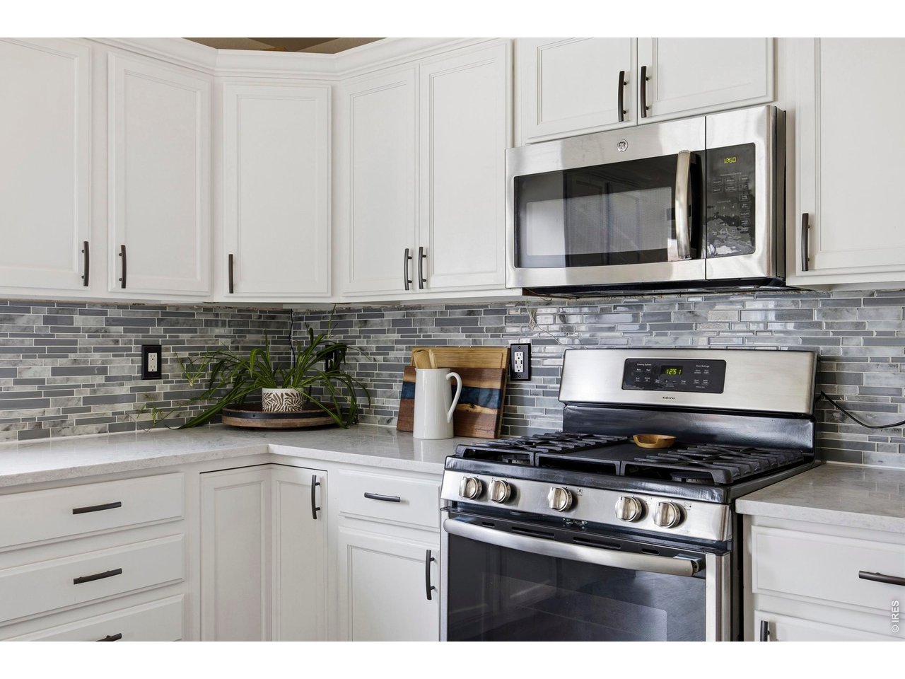 414 Prairie Clover Way Severance, CO 80550 - Photo 12 of 49 a kitchen with stainless steel appliances granite countertop a stove microwave and cabinets