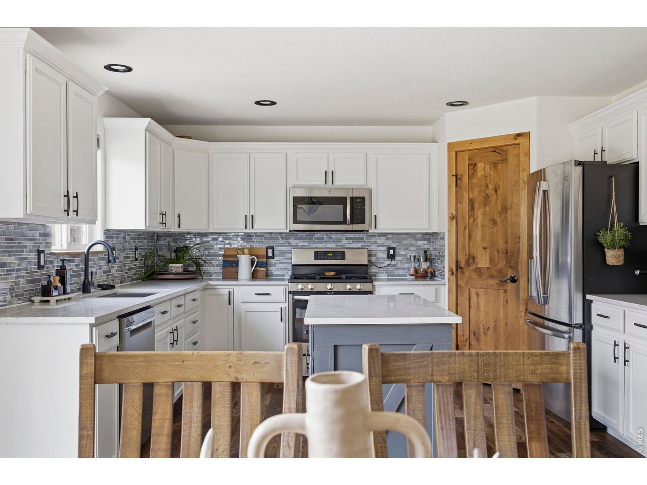 414 Prairie Clover Way Severance, CO 80550 - Photo 14 of 49 a kitchen with granite countertop a refrigerator oven a sink a stove and cabinets