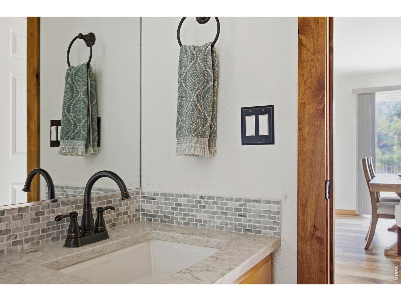 414 Prairie Clover Way Severance, CO 80550 - Photo 17 of 49 a bathroom with a sink and a mirror