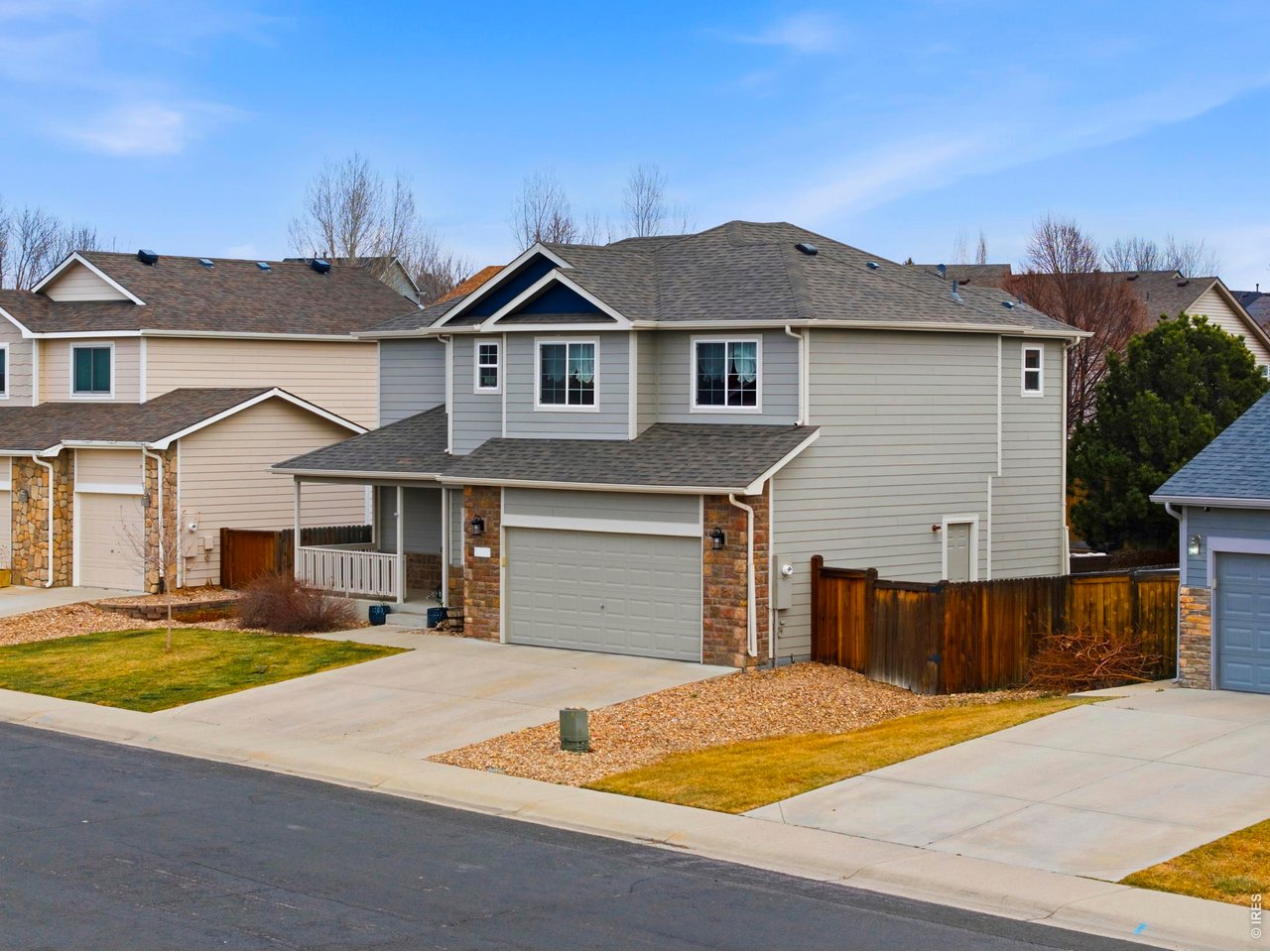 414 Prairie Clover Way Severance, CO 80550 - Photo 3 of 49 a front view of a house with yard and parking