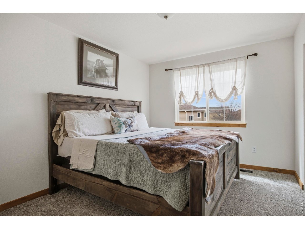 414 Prairie Clover Way Severance, CO 80550 - Photo 31 of 49 a bedroom with a bed and window
