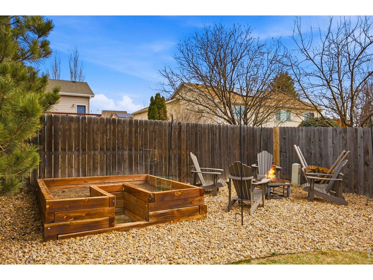 414 Prairie Clover Way Severance, CO 80550 - Photo 38 of 49 a backyard of a house with table and chairs