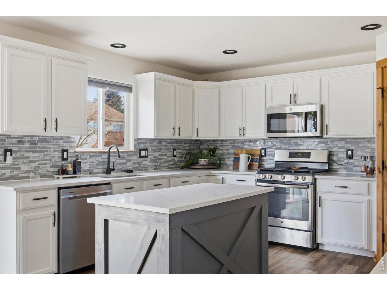 414 Prairie Clover Way Severance, CO 80550 - Photo 10 of 49 a kitchen with stainless steel appliances a sink stove and microwave