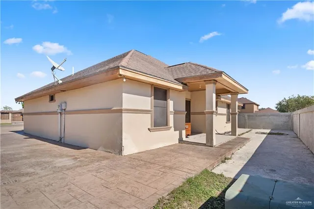 a view of a house with a wooden fence