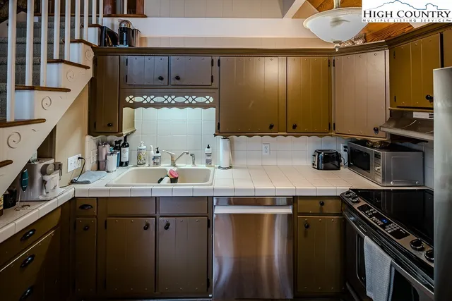 a kitchen with a sink a stove and cabinets