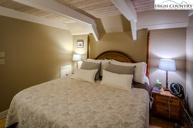 a bedroom with a bed and a lamp