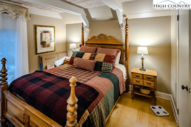 a bedroom with a bed and a mirror