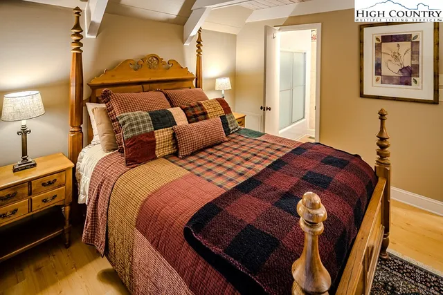 a bedroom with a bed and a painting on the wall