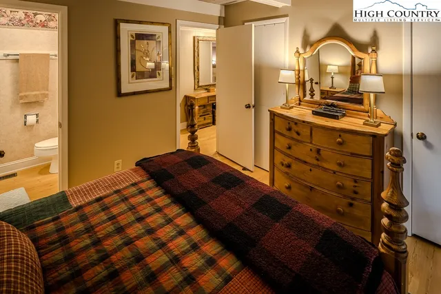 a bedroom with a bed and with furniture