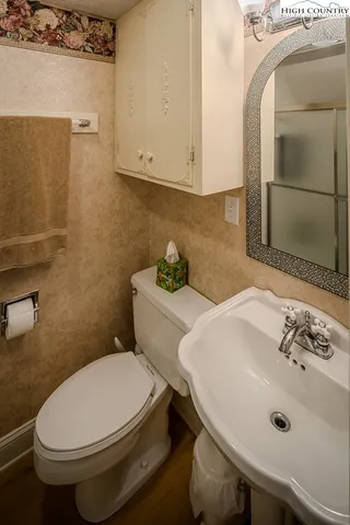 a white toilet sitting next to a bathroom sink