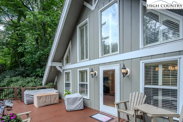 front view of a house with a chairs and table in a patio