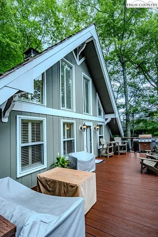 a front view of a house with cars parked