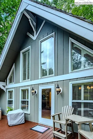 a view of house with a chairs and table in a patio