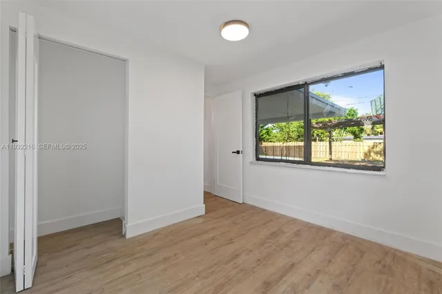 a bathroom with a toilet sink vanity and shower