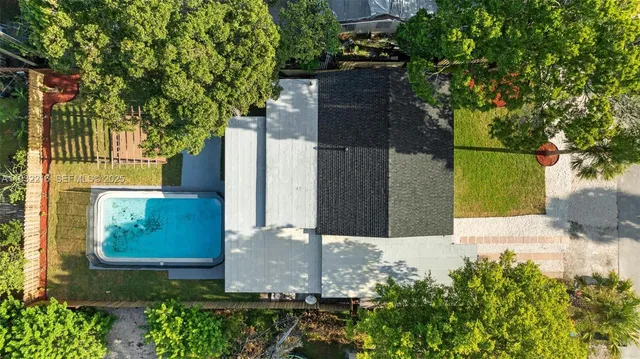 an aerial view of residential houses and outdoor space