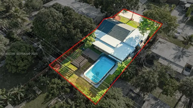 an aerial view of a house with a yard and lake view