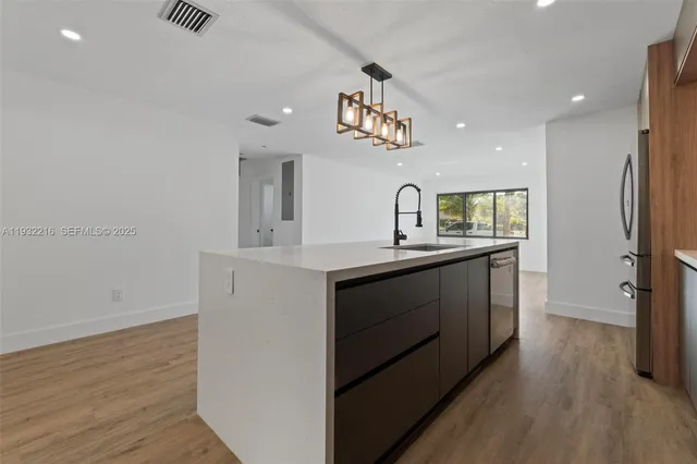a big room with wooden floor and windows