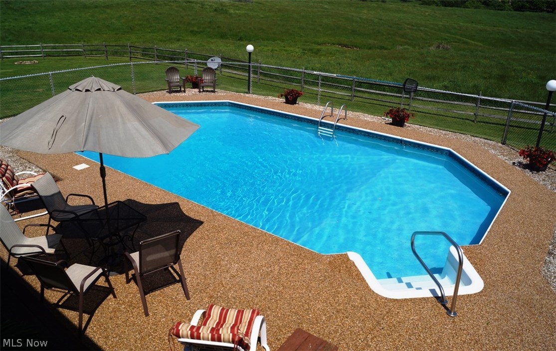 8472 Lowmiller Road Minerva, OH 44657 - Photo 26 of 35 MAKE A SPLASH IN THE GORGEOUS POOL! COMPLETE WITH NATURE STONE PATIO AREA.