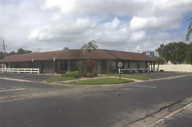 a view of street with brick house in front of it