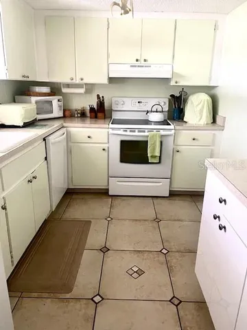 a kitchen with a stove top oven sink and cabinets