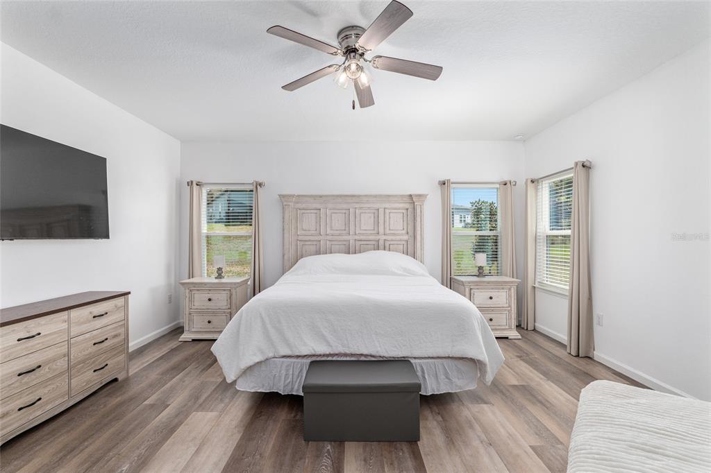 19692 Southwest 77th Loop Dunnellon, FL 34432 - Photo 11 of 20 a spacious bedroom with a bed and a flat screen tv