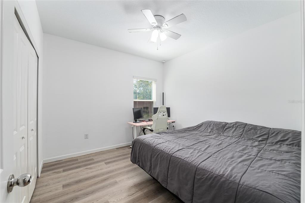 19692 Southwest 77th Loop Dunnellon, FL 34432 - Photo 6 of 20 a bedroom with a bed and a chandelier
