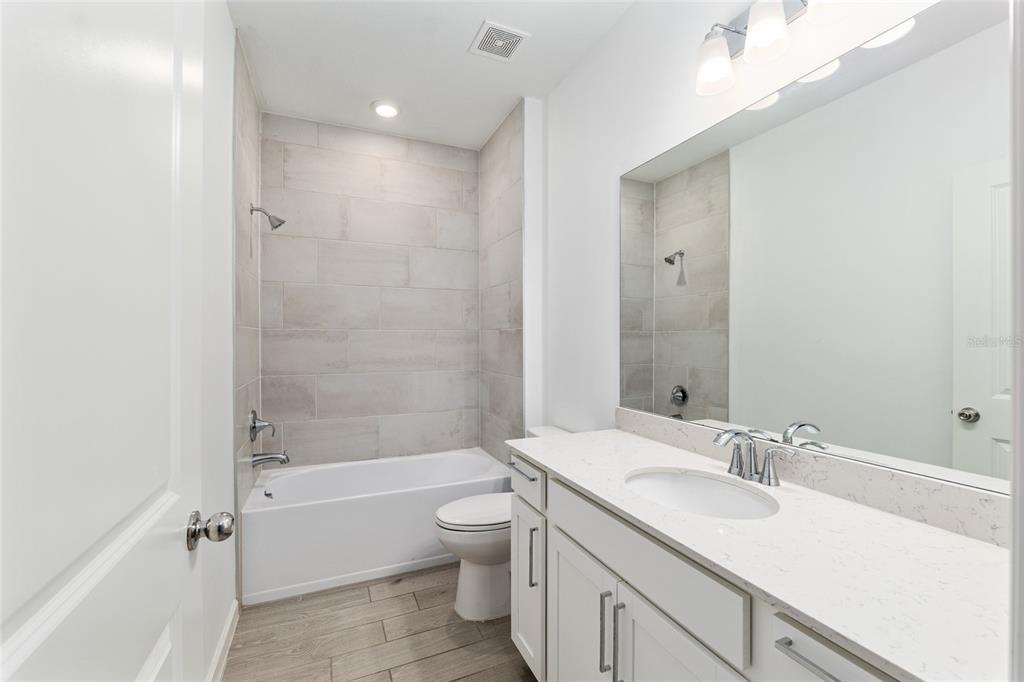 19692 Southwest 77th Loop Dunnellon, FL 34432 - Photo 7 of 20 a bathroom with a granite countertop sink a toilet and shower