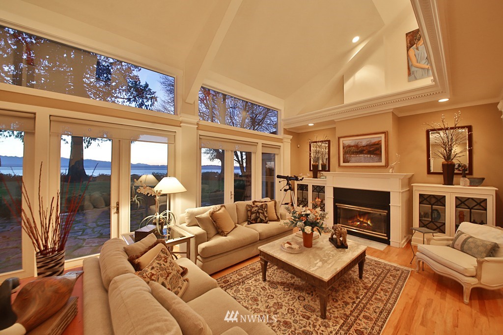 7120 Maxwelton Road Clinton, WA 98236 - Photo 12 of 25 a living room with furniture a fireplace and a flat screen tv