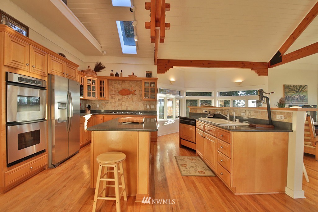 7120 Maxwelton Road Clinton, WA 98236 - Photo 14 of 25 a kitchen with stainless steel appliances granite countertop a stove and a wooden floors