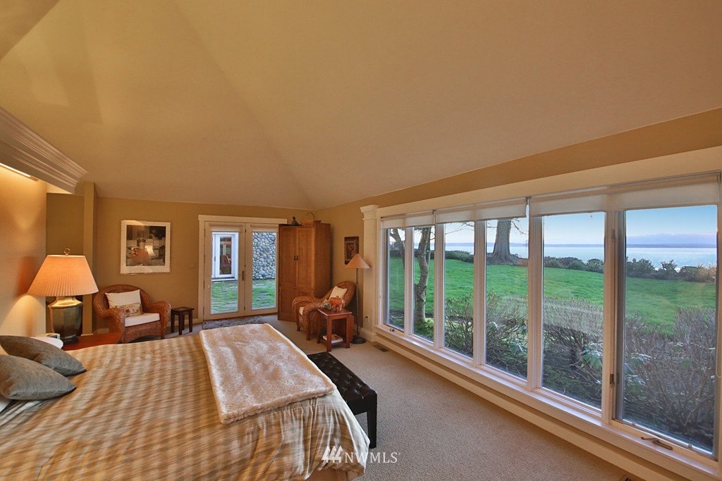 7120 Maxwelton Road Clinton, WA 98236 - Photo 16 of 25 a bed sitting in a spacious bedroom next to a large window