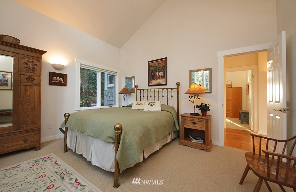 7120 Maxwelton Road Clinton, WA 98236 - Photo 20 of 25 a bed sitting in a spacious bedroom next to a window