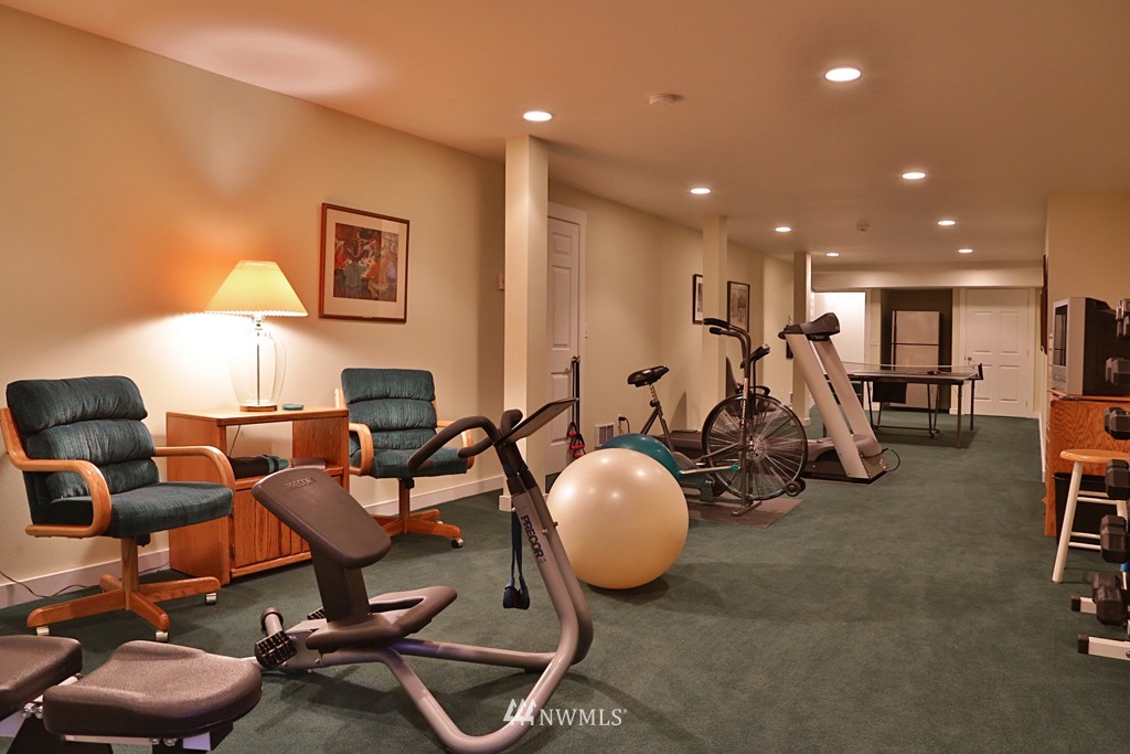 7120 Maxwelton Road Clinton, WA 98236 - Photo 23 of 25 a room with gym equipment and a view of living room