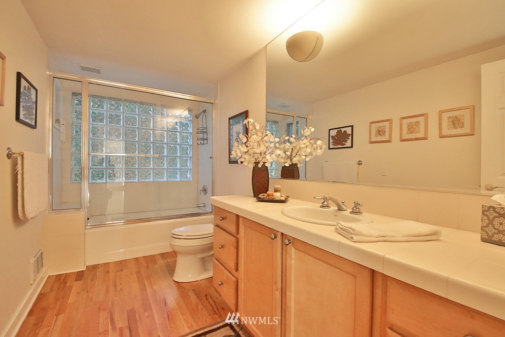 7120 Maxwelton Road Clinton, WA 98236 - Photo 24 of 25 a bathroom with a granite countertop sink mirror vanity and toilet